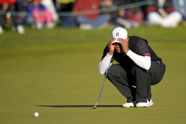 Tiger Woods lines up a putt on the 18th green at the World Challenge in California