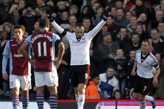 Fulham striker Dimitar Berbatov celebrates after scoring a penalty against Aston Villa