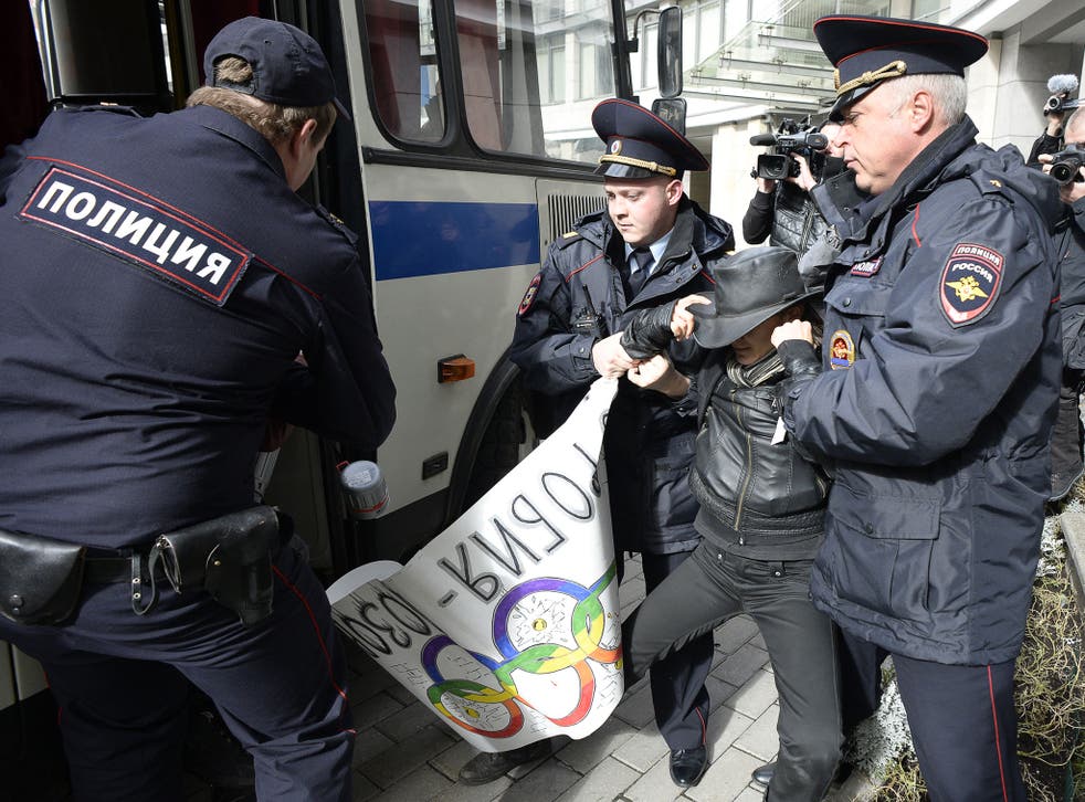 Police officers detain a gay rights activist during a protest in Russia. Irina Putilova has said that the new anti-gay legislation in Russia had increased homophobic violence
