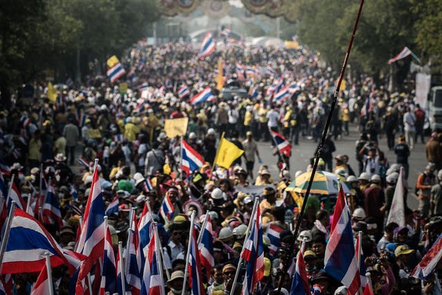 Demonstrators marching towards Government House in Bangkok; an estimated 100,000 protesters flooded the streets 