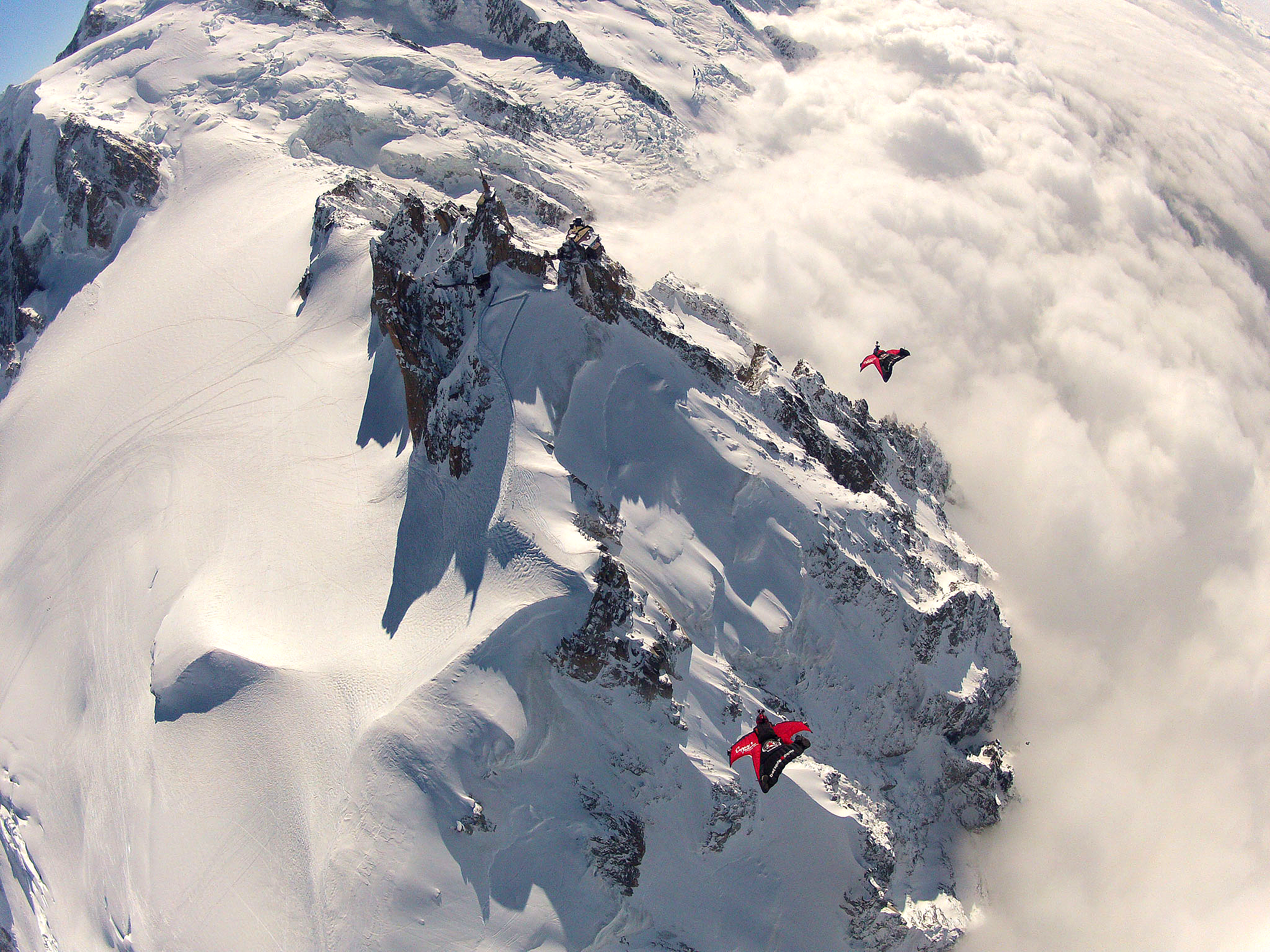 Espen Fadnes and Jokke Sommer descending to fly under the bridge at the top of Aiguille du Midi, 4,000m above Chamonix, France