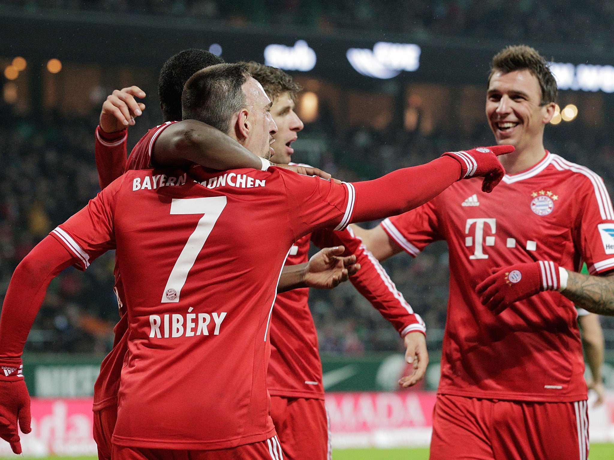 Bayern Munich winger Franck Ribery is congratulated by team-mates after scoring during the Bundesliga match against Werder Bremen on Saturday