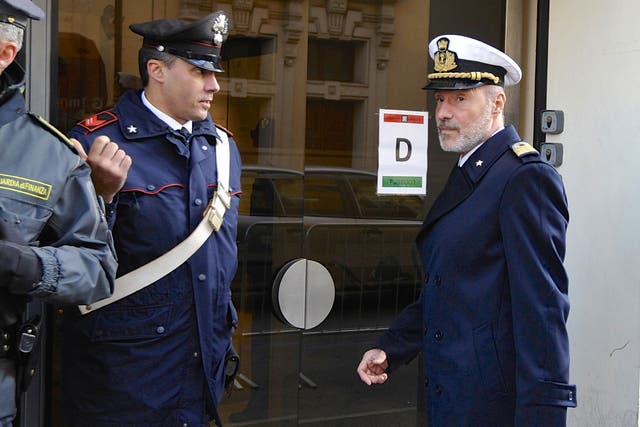 Coast Guard Captain Gregorio De Falco, right, arrives at the Grosseto court - the court was told hundreds of people were still aboard the shipwrecked Costa Concordia when the commander abandoned the cruise liner in a lifeboat