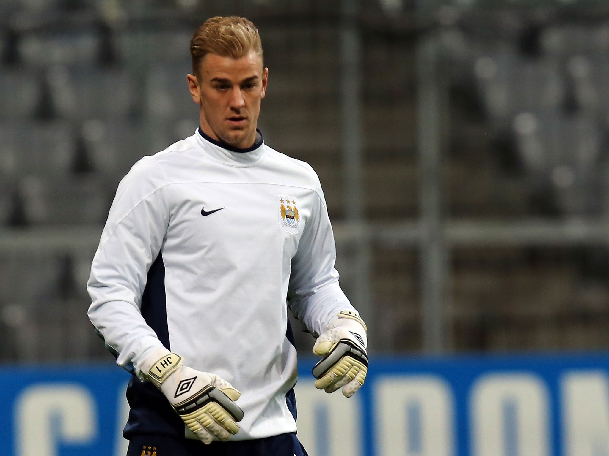 Goalkeeper Joe Hart plays the ball during a Manchester City training session at Allianz Arena