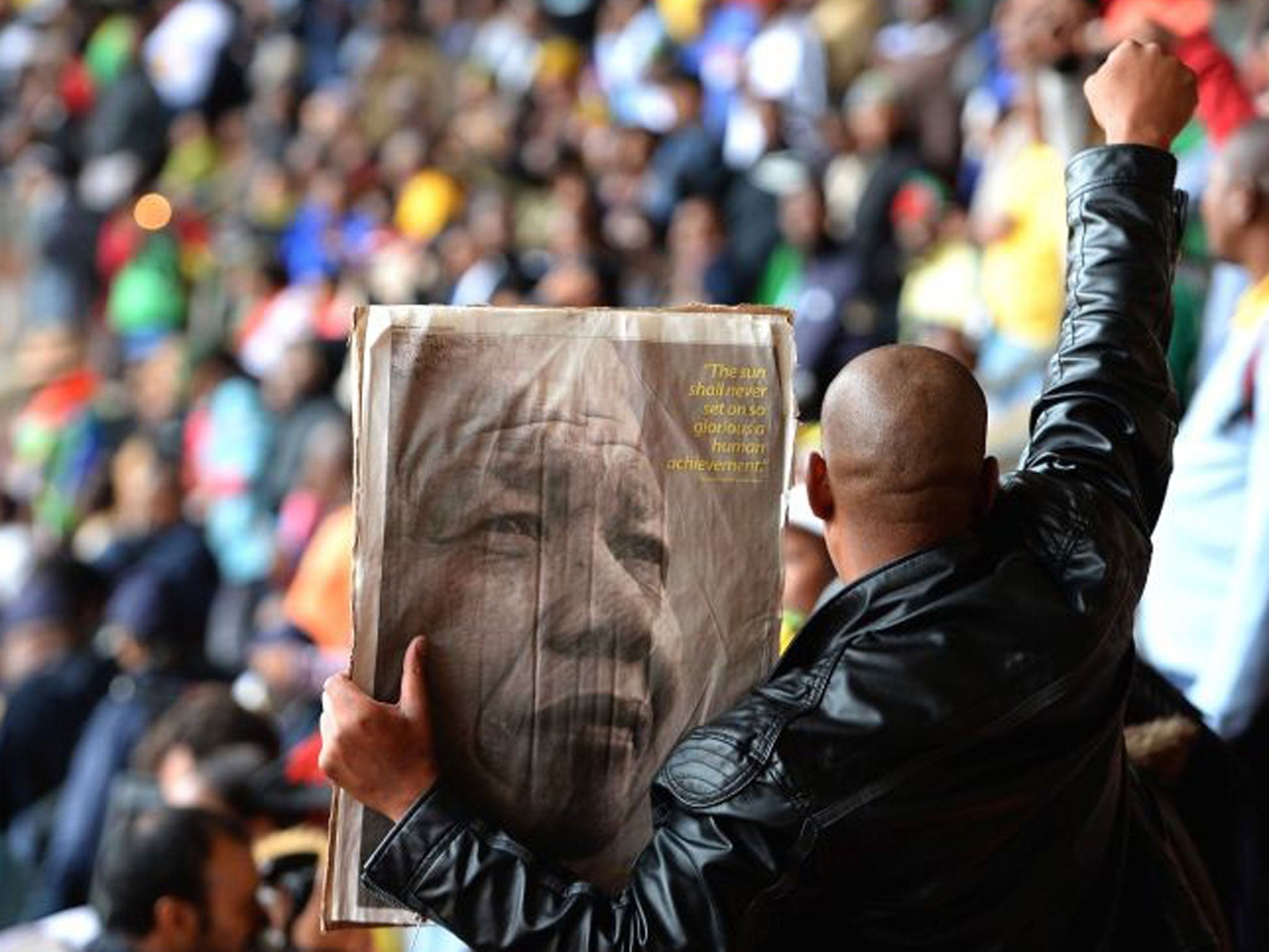 Members of the public sing and dance inside the FNB Stadium, on December 10, 2013 in Johannesburg, South Africa