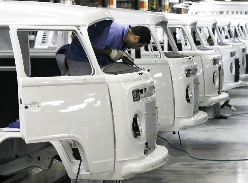 A labourer works on the assembly line of the Volkswagen Kombi at the Volkswagen plant in Sao Bernardo do Campo, Brazil