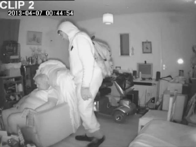 CCTV footage dated 07/04/2013 issued by Derbyshire Constabulary showing burglar Patrick Reid, 51, raiding the home of pensioner Margaret Woodward, 68, as she naps in an armchair at her home in Long Eaton, Derbyshire