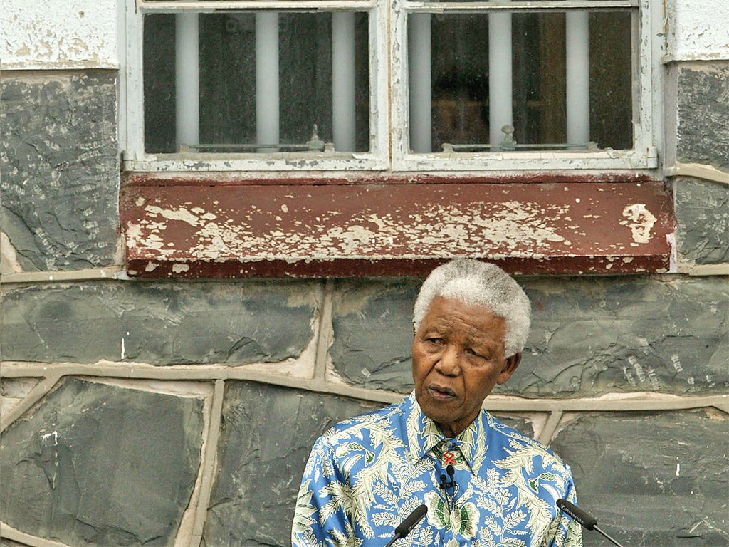 Nelson Mandela delivers a speech outside his former prison cell, in 2003 (Getty)