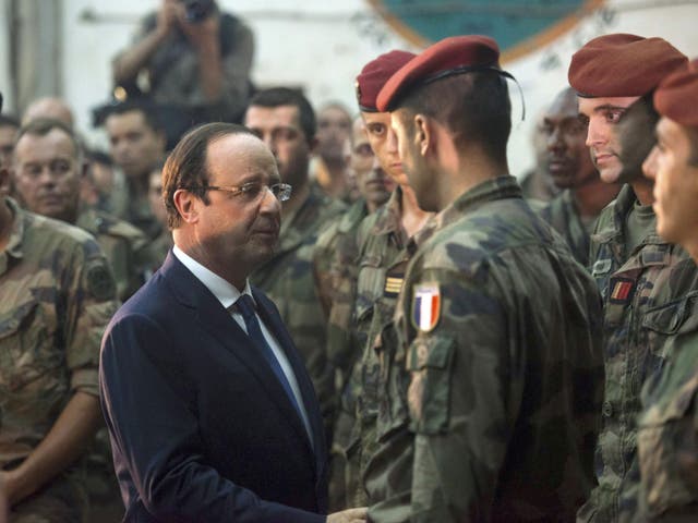French President Francois Hollande speaks with French soldiers after he paid tribute to two French soldiers who were killed overnight, in Bangui