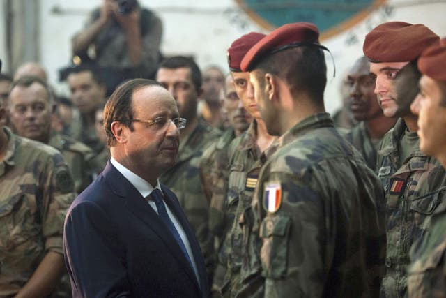 French President Francois Hollande speaks with French soldiers after he paid tribute to two French soldiers who were killed overnight, in Bangui
