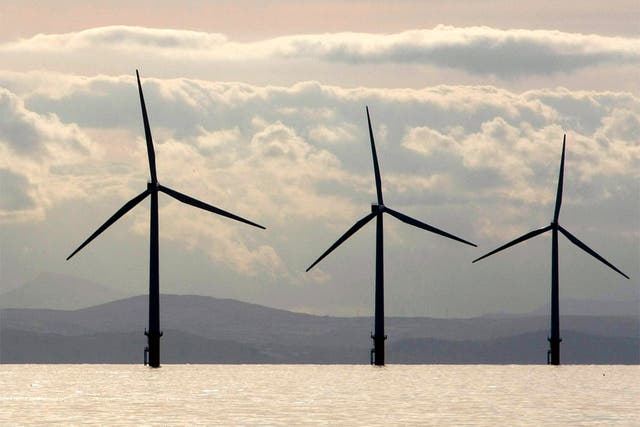 Turbines of the Burbo Bank off shore wind farm adorn the skyline in the mouth of the River Mersey