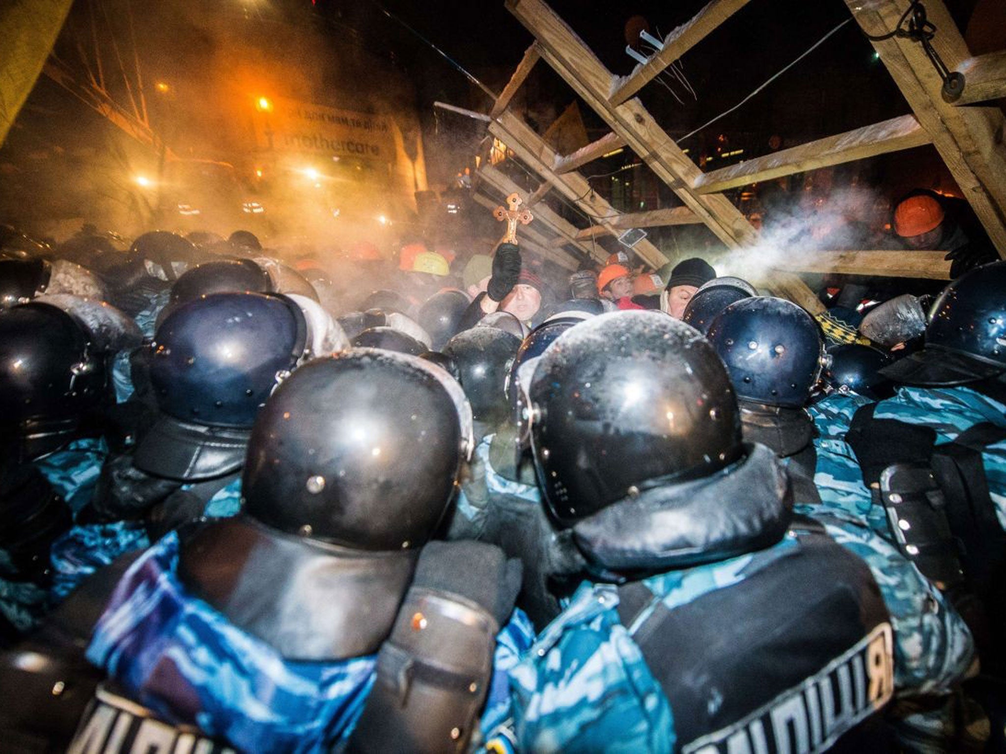Riot police assault a  barricade held by protesters on Independence Square in Kiev late on 11 December, 2013
