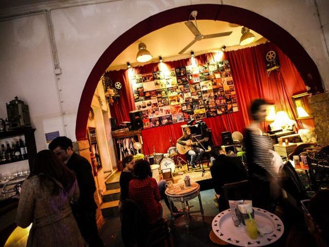 People talk and listen to live music in a bar of the Bairro Alto district of Lisbon, Portugal