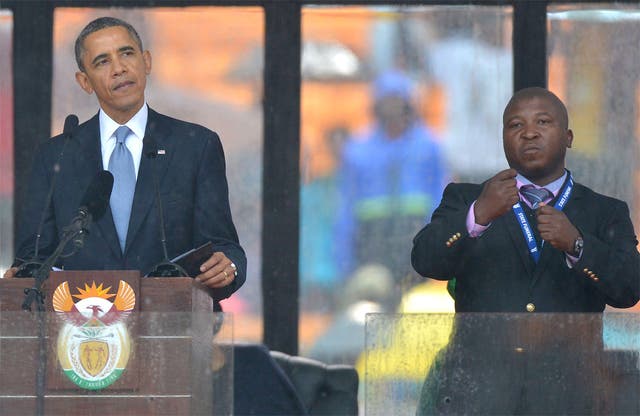 Obama delivers his speech next to a sign language interpreter, who has been accused of being a fake