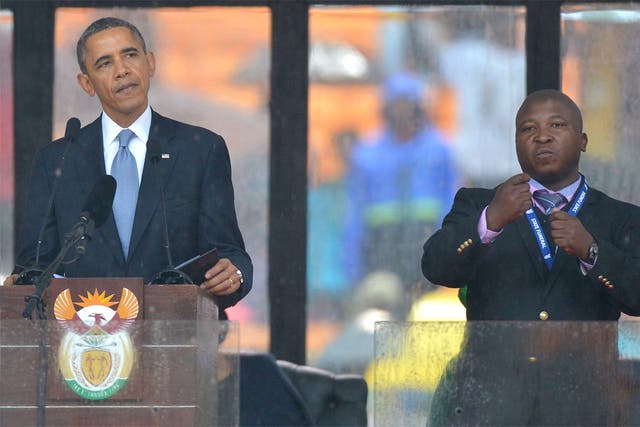 Obama delivers his speech next to a sign language interpreter, who has been accused of being a fake