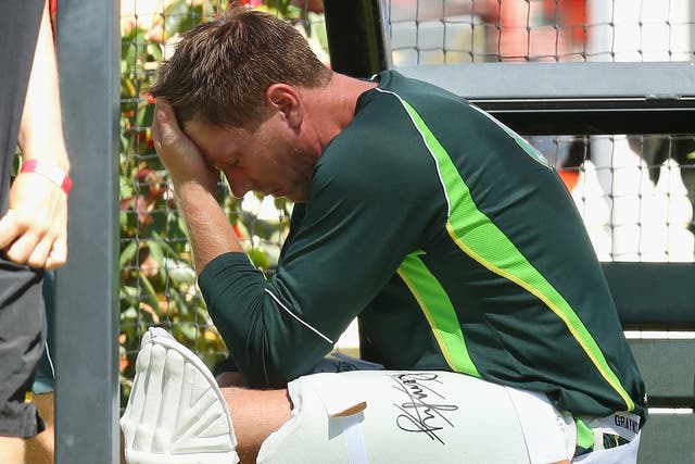 Australia's James Faulkner looks dejected after suffering a broken thumb when he was hit on the hand during a nets session