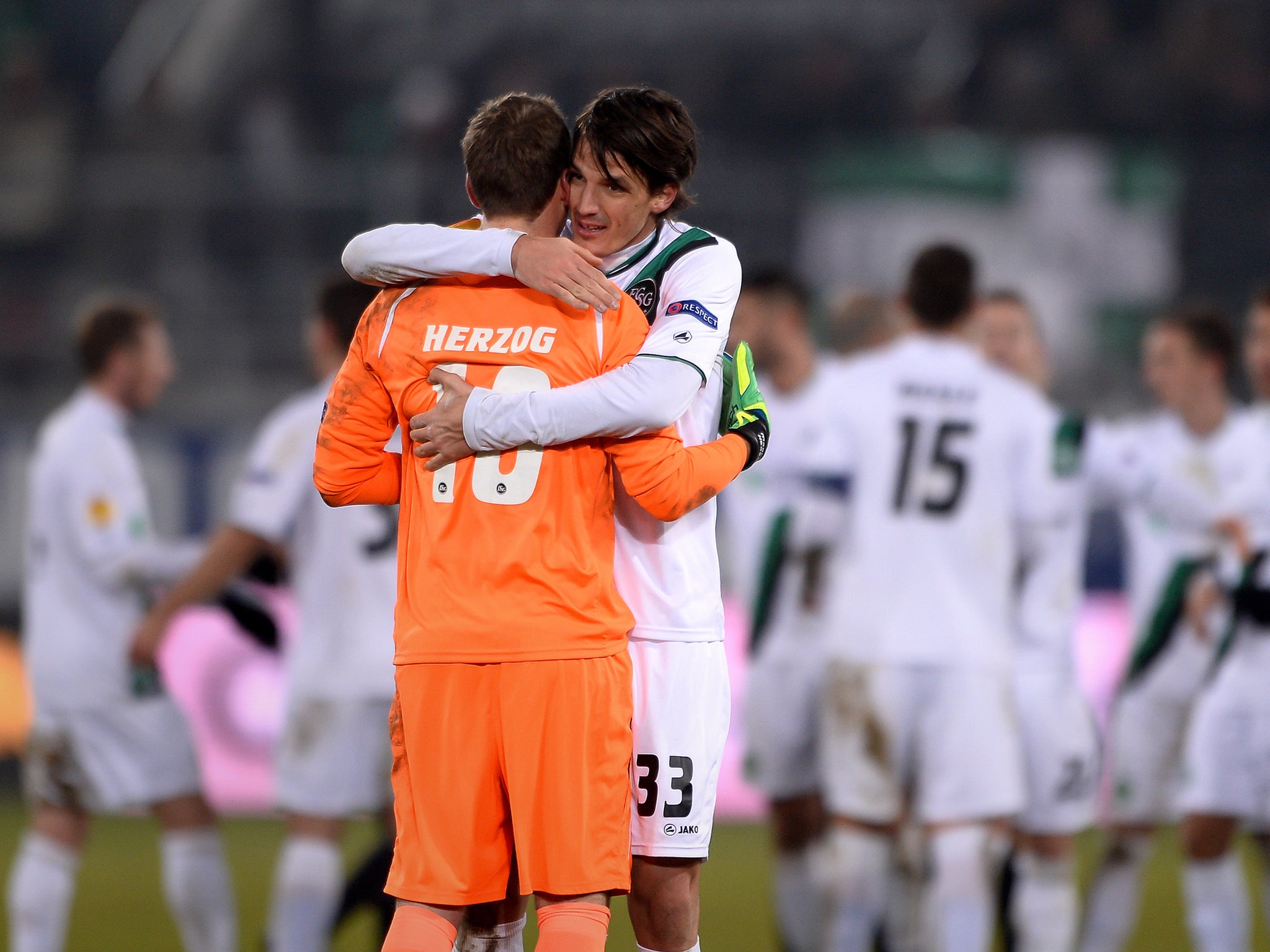 Swansea defender Ben Davies embraces his goalkeeper Marcel Herzog despite the 1-0 defeat to St Gallen following their Europa League progression