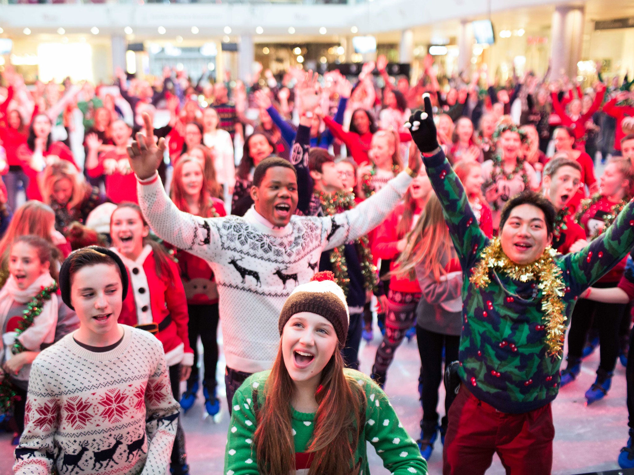People perform a dance routine to mark the Christmas Jumper Day in London