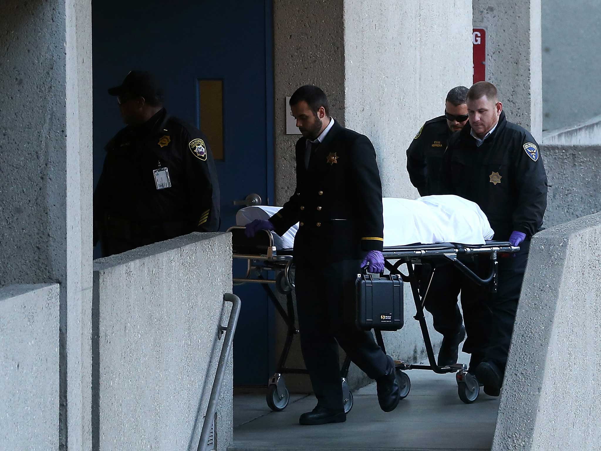 The San Francisco medical examiner moves the body of Lynne Spalding on a gurney at San Francisco General Hospital