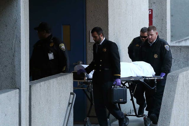 The San Francisco medical examiner moves the body of Lynne Spalding on a gurney at San Francisco General Hospital