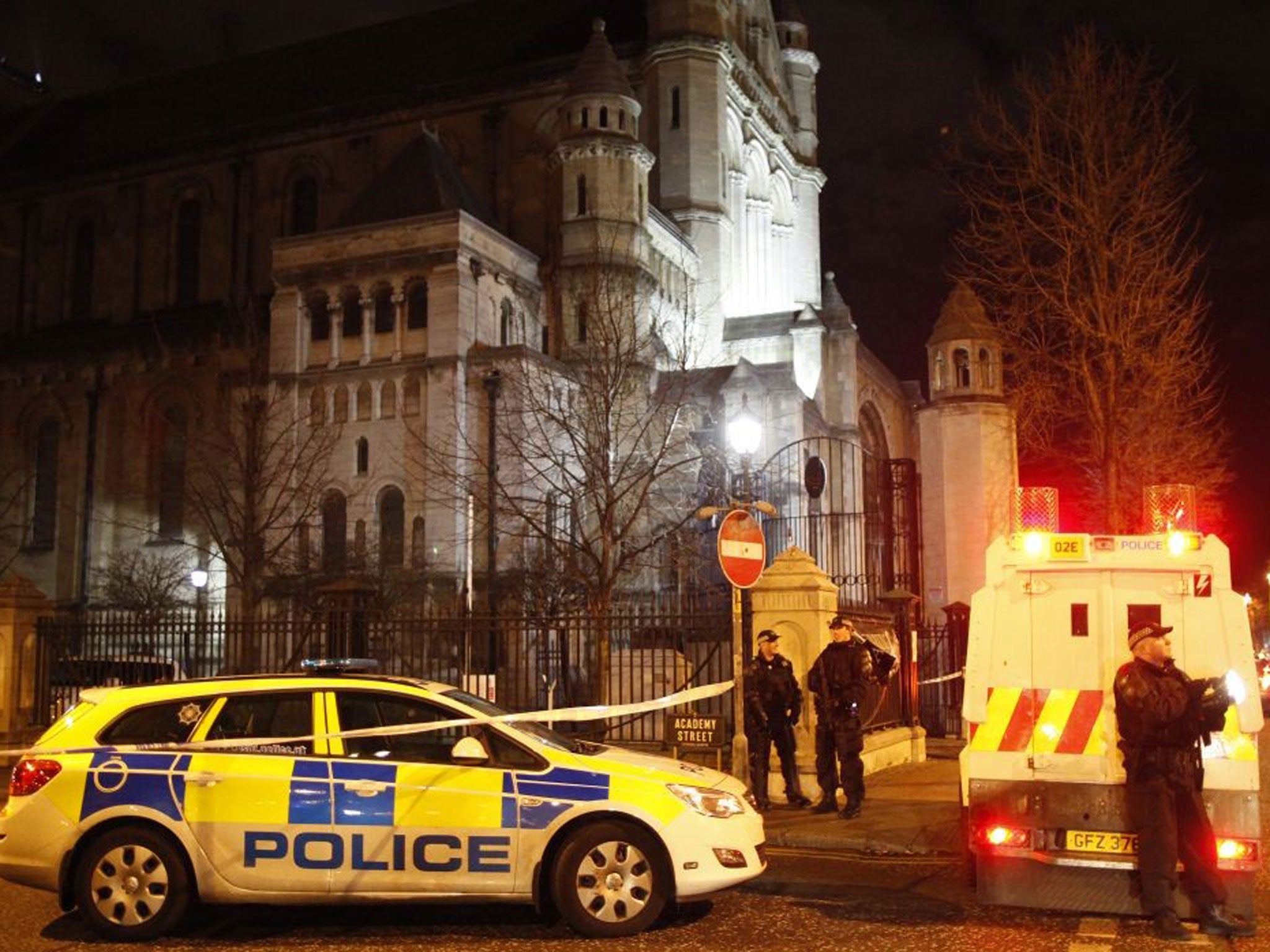 Police officers secure the area close to the scene of a small explosion in the Cathedral Quarter in Belfast city centre, Northern Ireland, Friday, 13 Dec 2013.