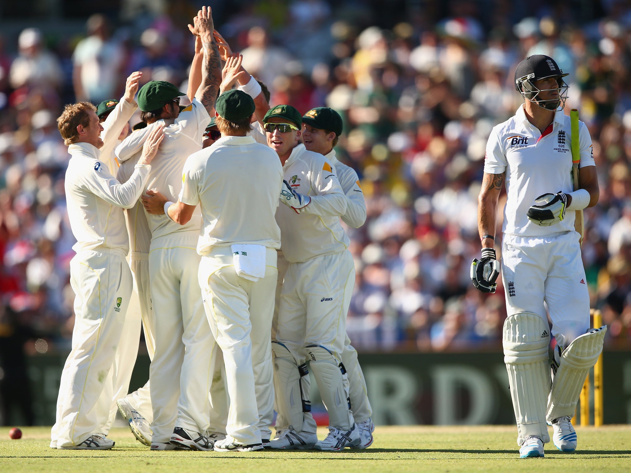 Kevin Pietersen walks off as Australia celebrate with Peter Siddle