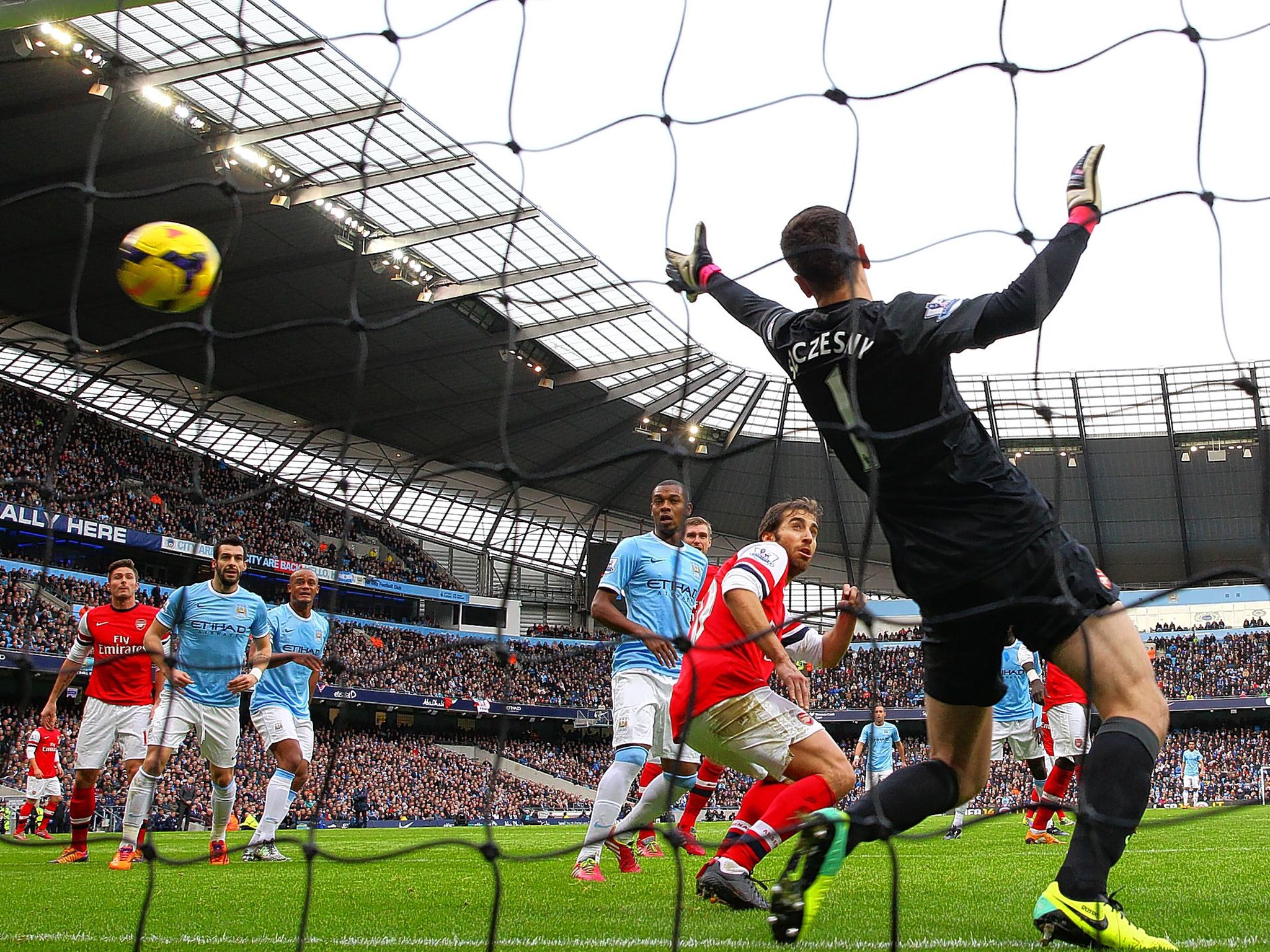Sergio Aguero (not pictured) puts Manchester City ahead witht he opening goal against Arsenal