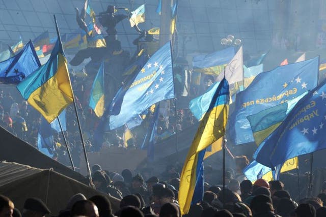 Protesters waving EU and Ukrainian flags in Kiev yesterday