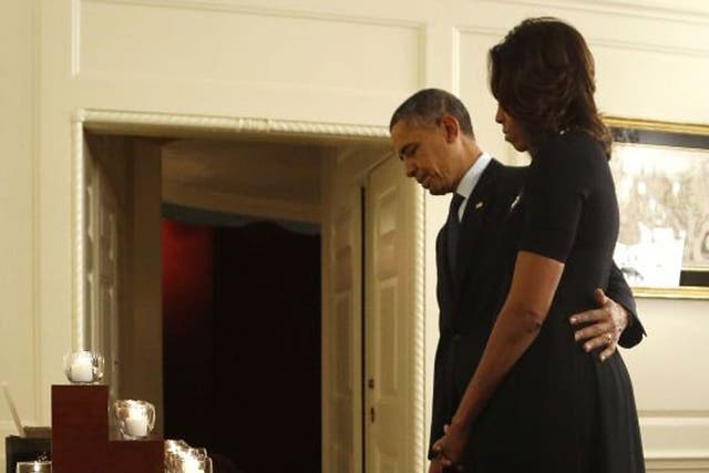 One year on: The President and Mrs Obama observe a minute’s silence for the Sandy Hook massacre