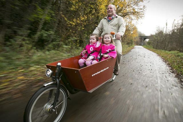 Going Dutch: Steven Patterson regularly takes his three-year-old twin daughter Lilly and Grace for spins on his cargo bike