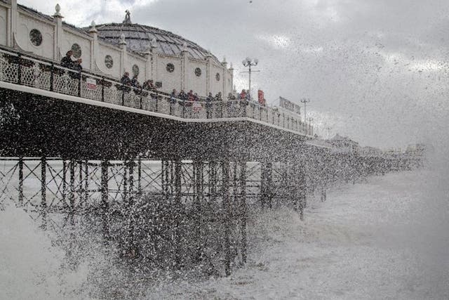 File photo of waves crashing near Brighton Pier on 27 October 2013, as forecasters warned of heavy wind and rain and 'Storm Emily' coming later in the week