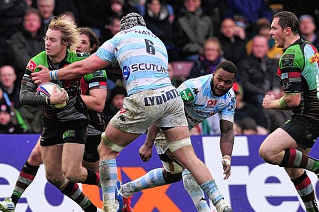 Harlequins’ Charlie Walker breaks a tackle to score a try against Racing Metro