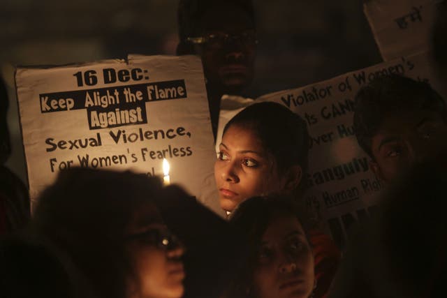 Indians students from the Jawaharlal Nehru University hold placards during a candle light vigil on the first anniversary of the fatal gang rape of a young woman in a bus