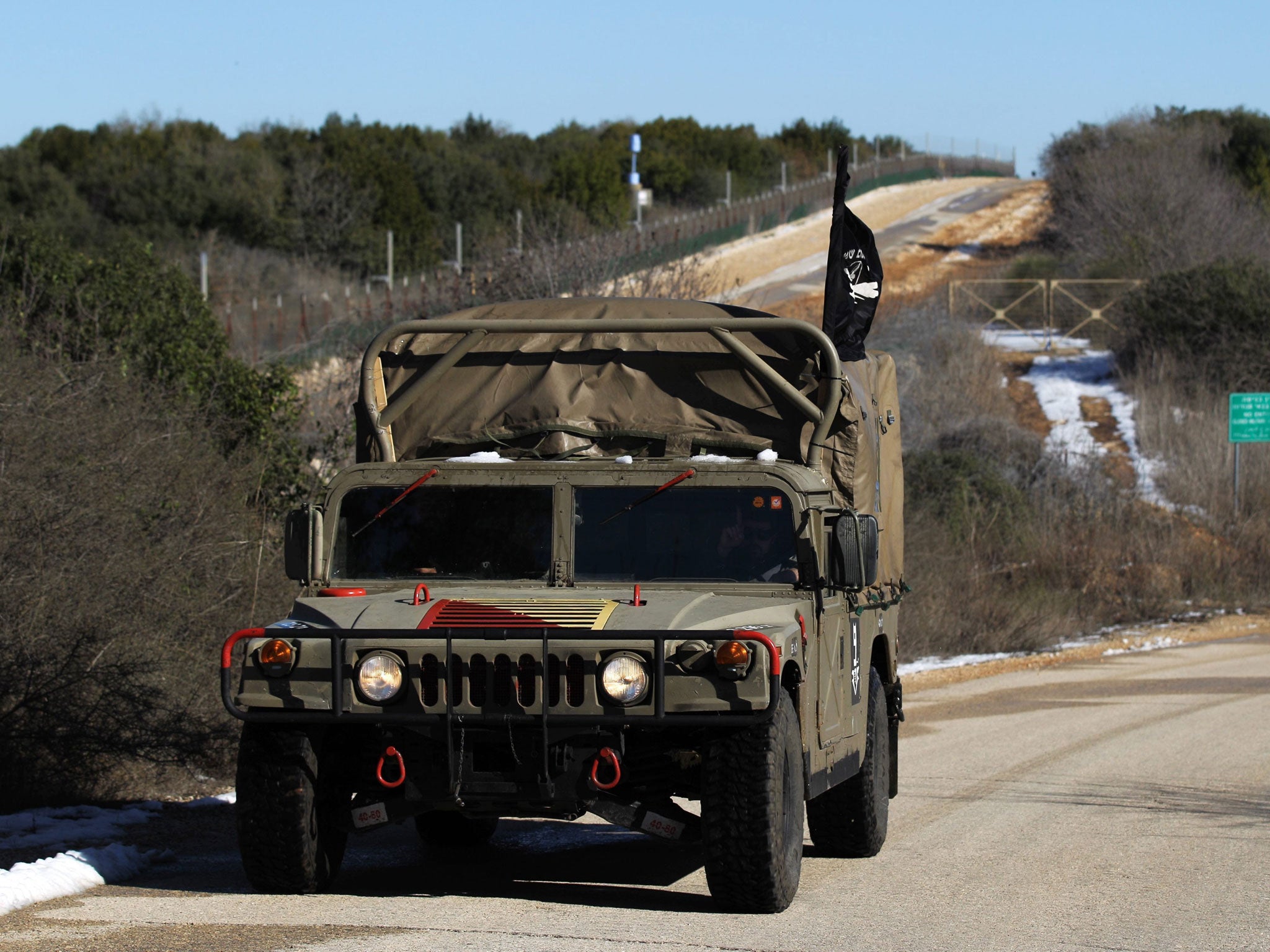 An Israeli armored military car patrols at the Israeli-Lebanon border