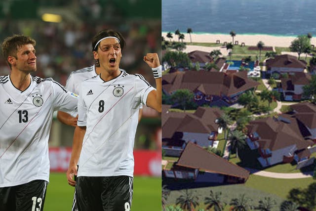 Left: Thomas Müller (l) and Mesut ?zil (r) celebrate scoring against Turkey to qualify for the Fifa World Cup 2014. Right: A computer graphic of the Campo Bahia facility which will house the German team next summer.