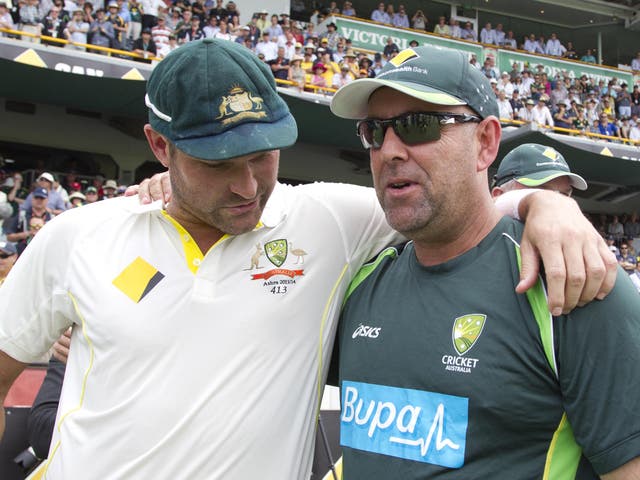 Australian cricket coach Darren Lehmann (R) celebrates with bowler Ryan Harris (L) after winning back the urn from England on the fifth day of the third Ashes cricket Test match in Perth
