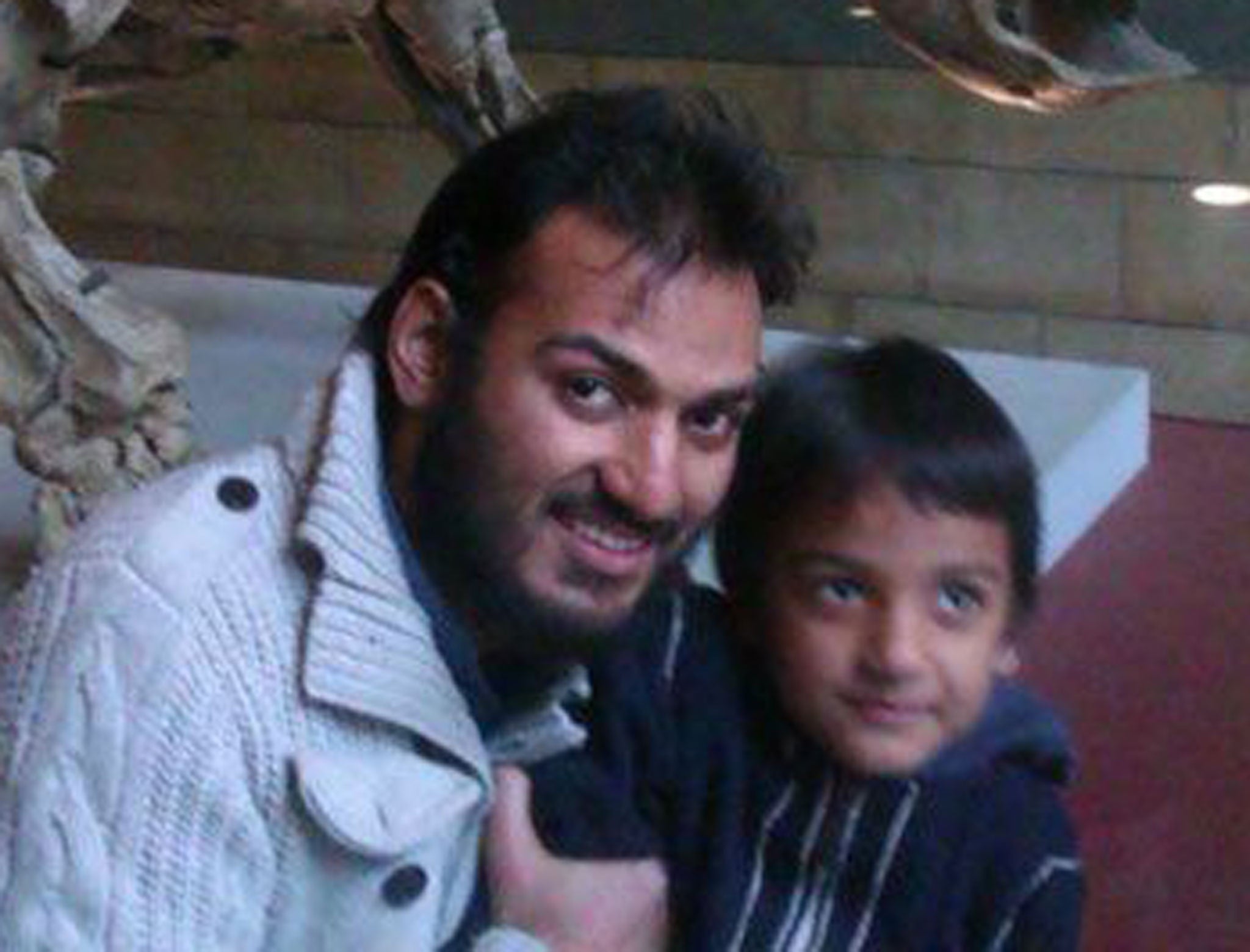 British surgeon Dr Abbas Khan, pictured here with his son, died in detention.