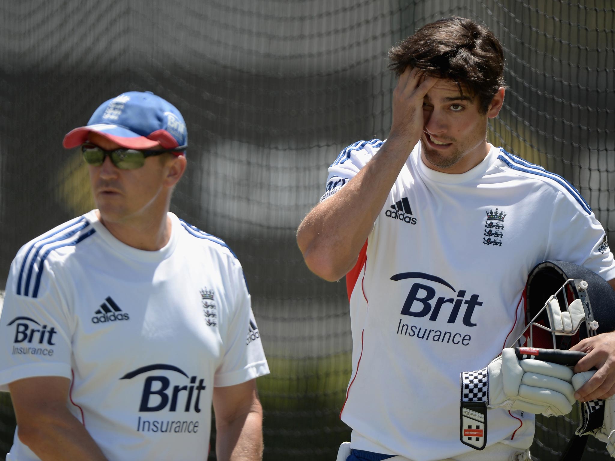 England captain Alastair Cook speaks with coach Andy Flower