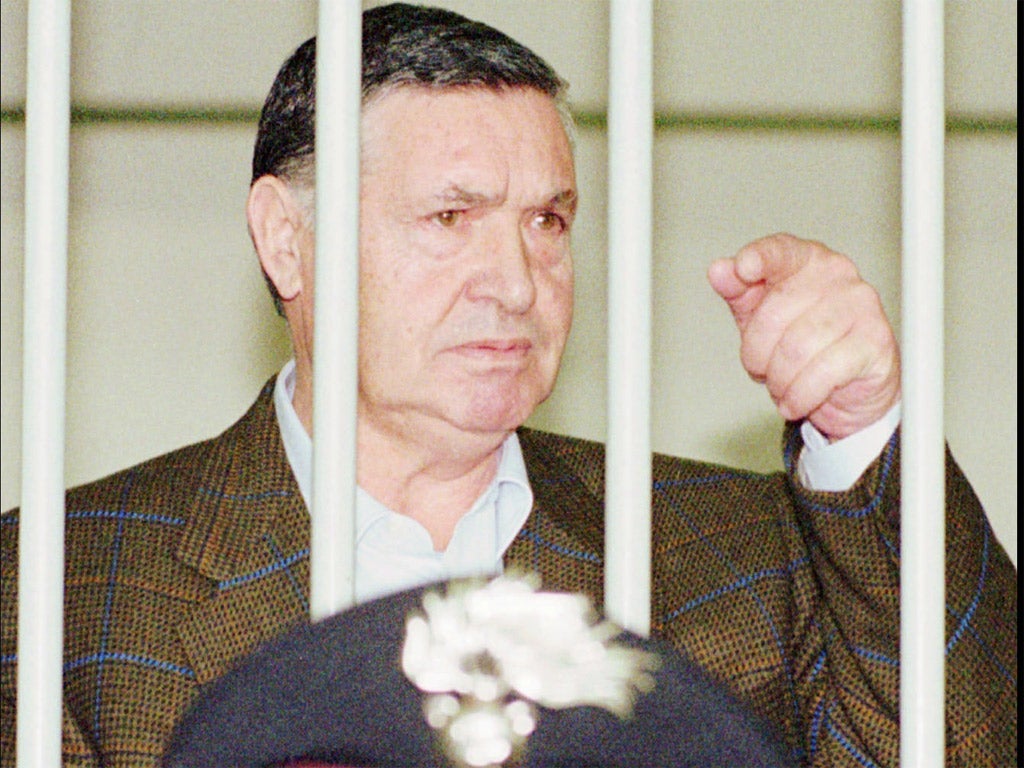 Salvatore Toto Riina behind bars during a trial in Rome