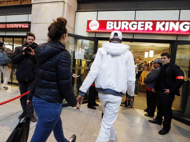 Diners enter a Burger King store at Saint-Lazare railway station in Paris