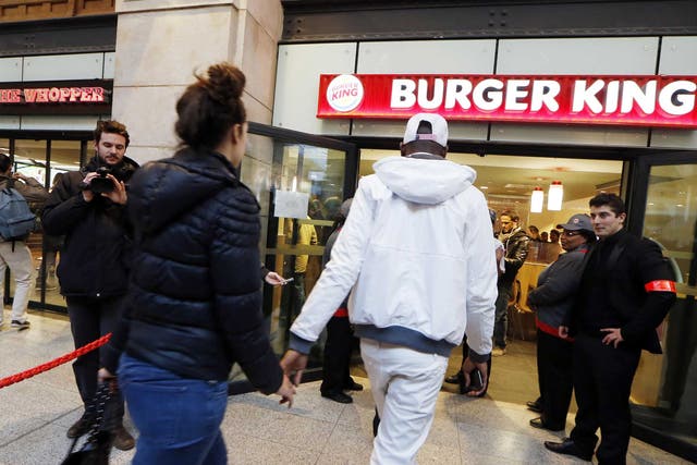 Diners enter a Burger King store at Saint-Lazare railway station in Paris