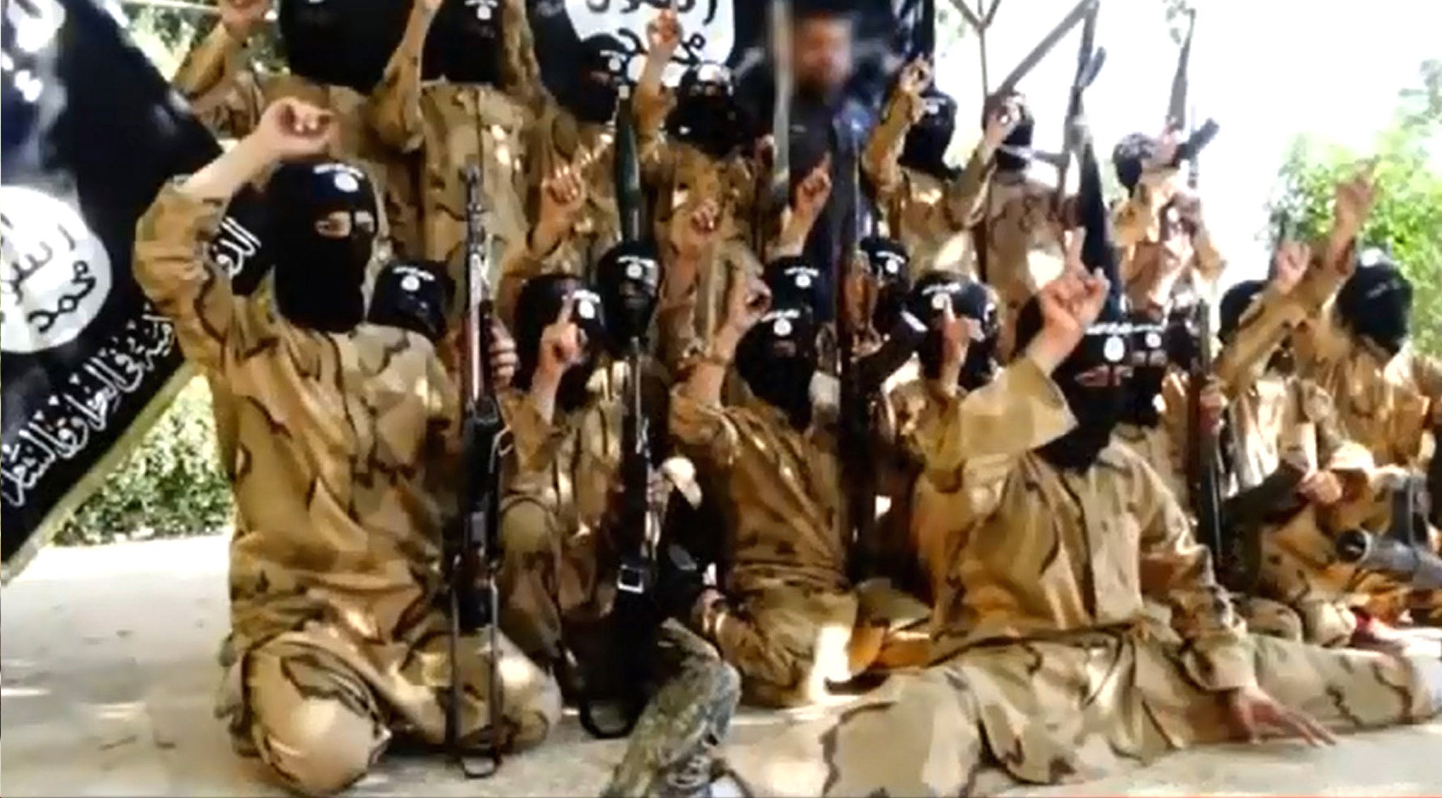 Young Syrian boys are seen on a video displaying their weapons