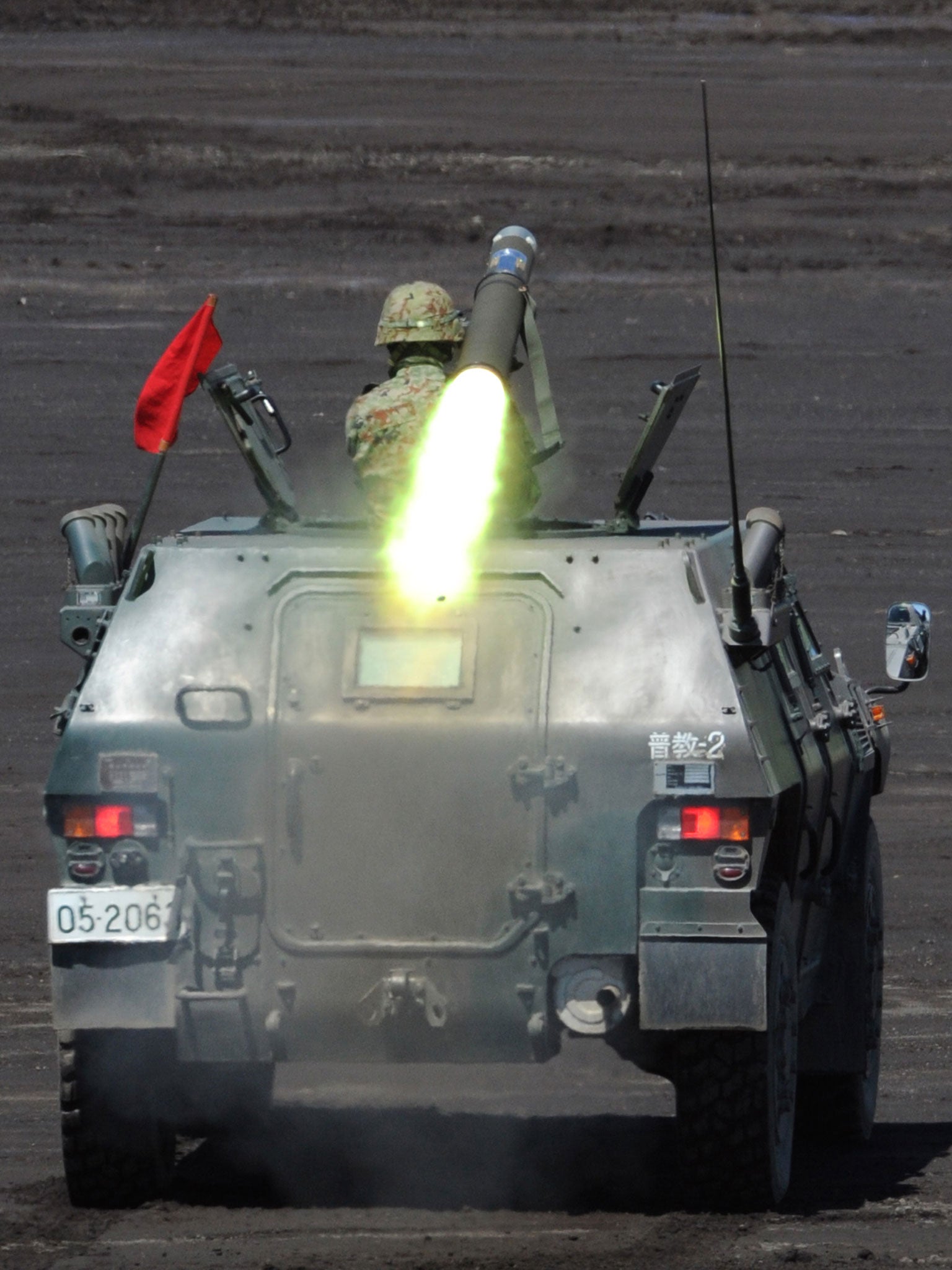 A soldier of Japan's Ground Self-Defense Forces fires an anti-tank missile from an armoured personel carrier during an annual live fire exercise at the Higashi-Fuji firing range in Gotemba, at the foot of Mt. Fuji in Shizuoka prefecture on August 21, 2012