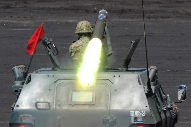 A soldier of Japan's Ground Self-Defense Forces fires an anti-tank missile from an armoured personel carrier during an annual live fire exercise at the Higashi-Fuji firing range in Gotemba, at the foot of Mt. Fuji in Shizuoka prefecture on August 21, 2012