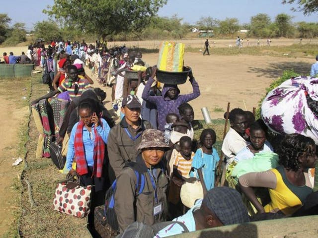 Civilians arrive for shelter at the United Nations Mission in the Republic of South Sudan (UNMISS) compound in Bor, South Sudan in this December 18, 2013 