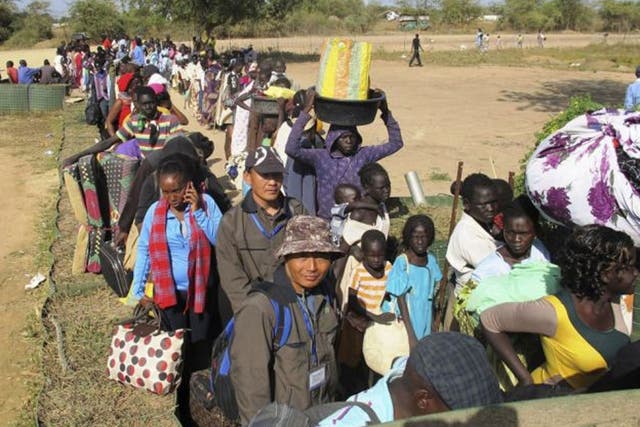 Civilians arrive for shelter at the United Nations Mission in the Republic of South Sudan (UNMISS) compound in Bor, South Sudan in this December 18, 2013 