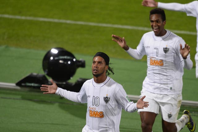 Atletico Mineiro forward Ronaldinho (L) celebrates with his teammate Jo after scoring a goal during their semi-final - however it wasn't enough to see them through to the final