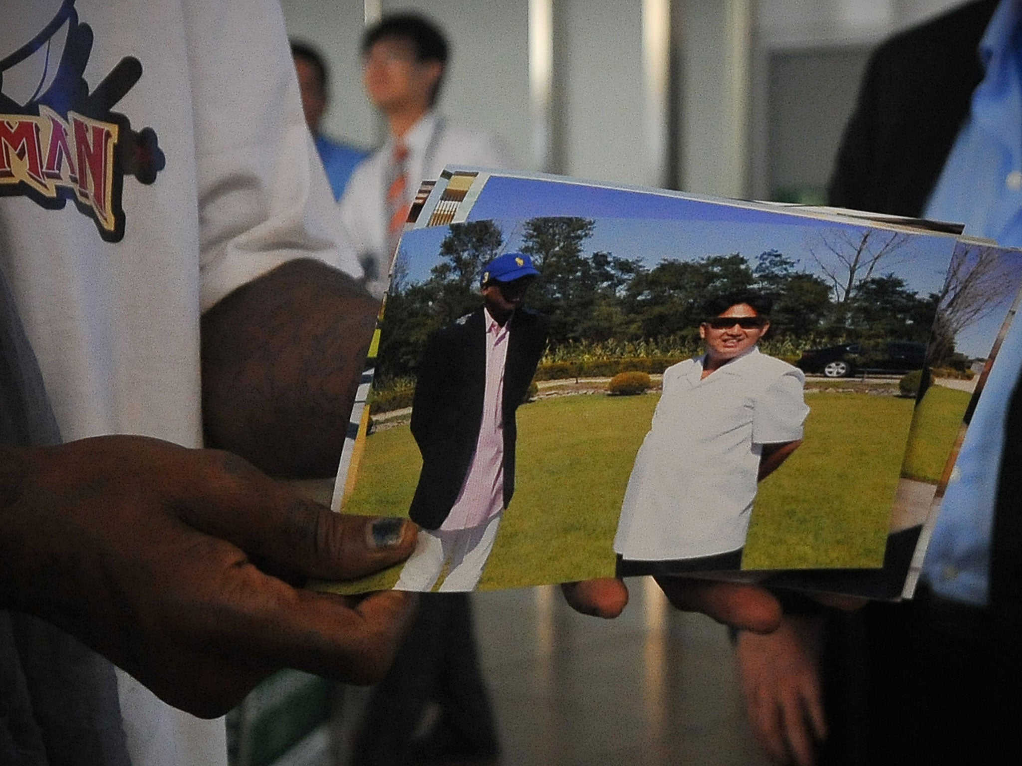 Rodman shows the media pictures of him reportedly with North Korea leader Kim-Jong-un