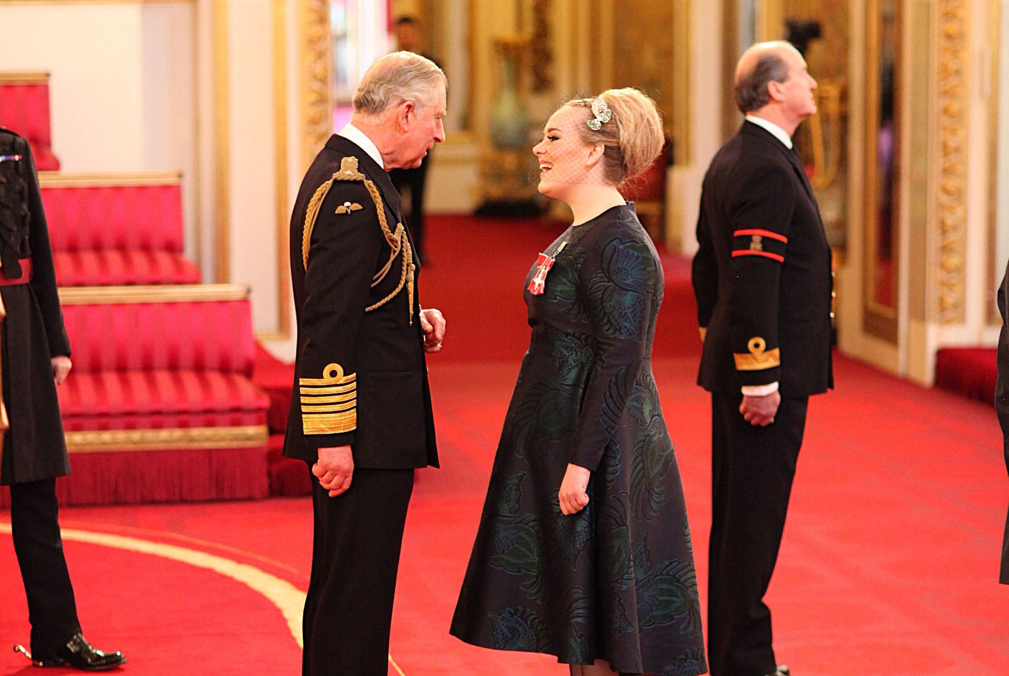 The “Someone Like You” singer beamed as she received her Most Excellent Order of the British Empire from Prince Charles at Buckingham Palace this morning, making her full title Miss Adele Adkins MBE