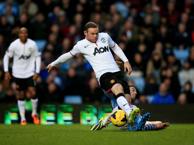 Wayne Rooney has a shot on goal blocked by Matthew Lowton during Manchester United's victory over Aston Villa